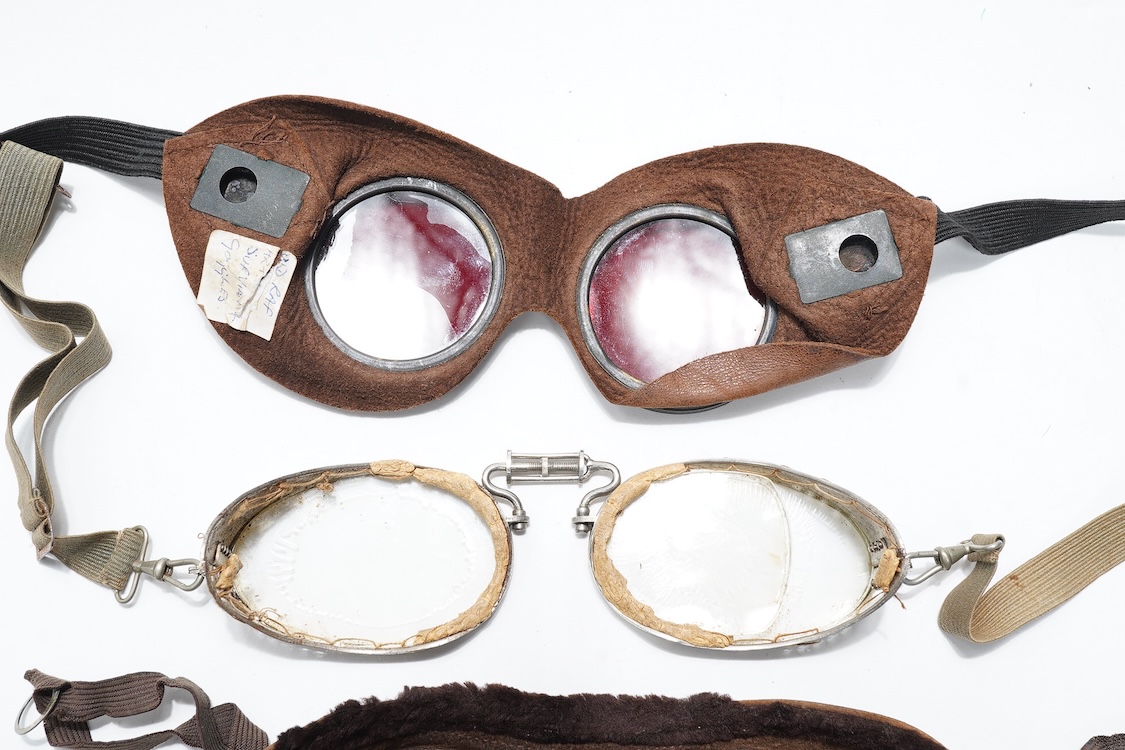 A pair of early aviation aluminium framed flying goggles, a pair of leather and felt lined goggles with green tinted lenses, a pair of French ? aviator flying goggles and a pair of WW2 First Pattern RAF Night Simulation